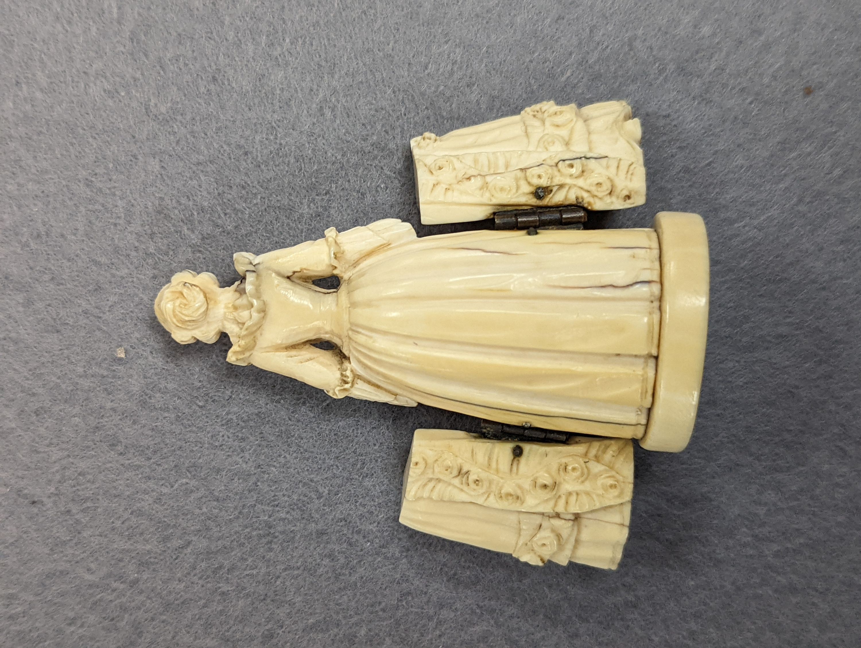 A pair of 19th century ivory balm pots, 3.75cm., a smallDieppe triptych figure, 6.5cm. a Meiji tiger brooch and a Dutch page marker.